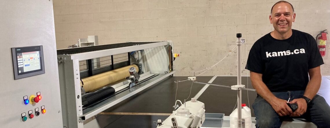 Kameron Fordyce with the Phormium mushroom net finishing unit newly installed at the Kam's Growers Supply location in Guelph ON.